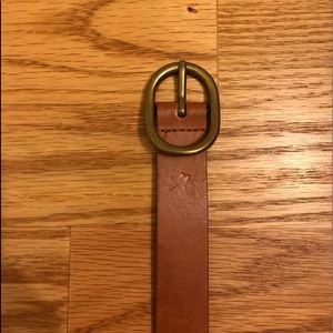Light brown colored belt with a gold buckle